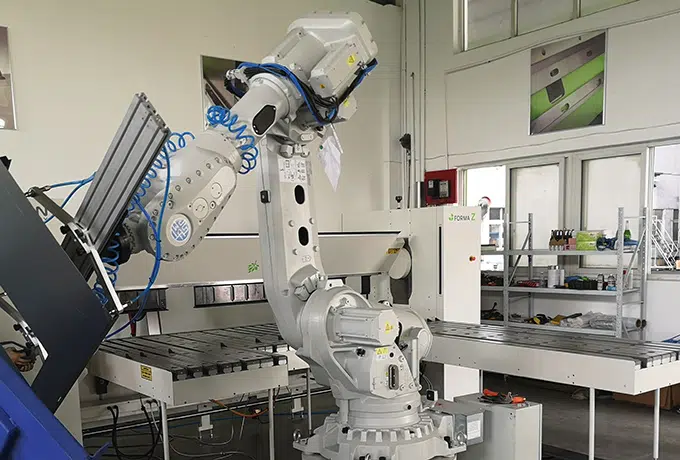 folding machine served by a robot on white background