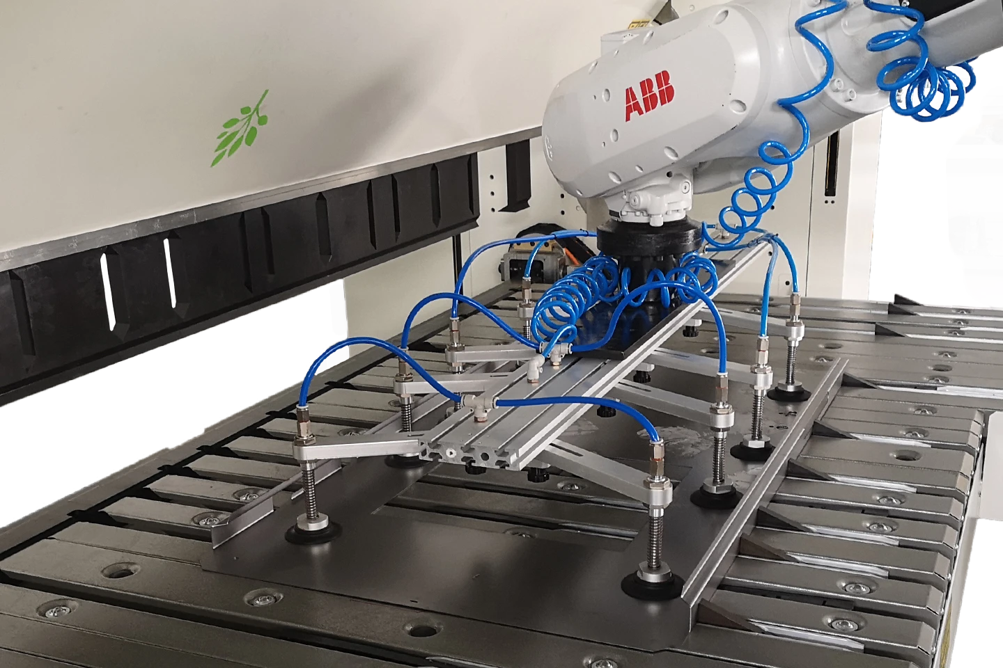 folding machine served by a robot on white background